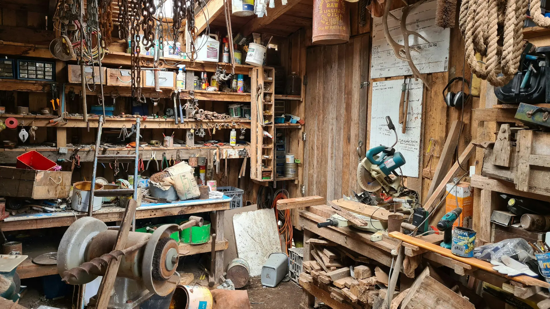 A very messy woodworking shop with scrapwood everywhere.