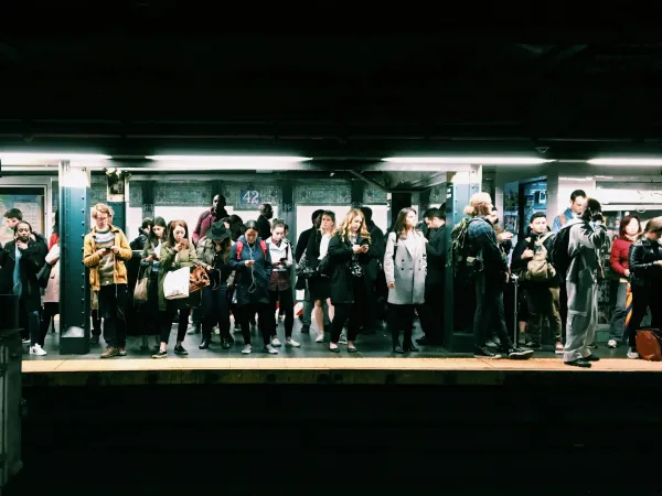 A group of people waiting for the subway in New York City at 42nd Street.