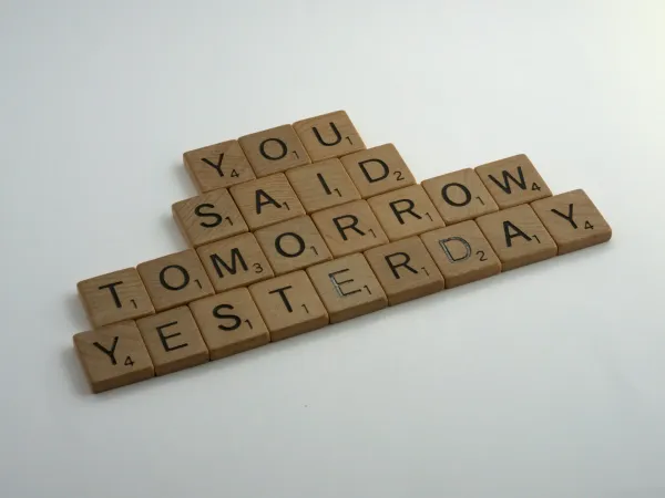 Scrabble pieces spelling out “you said tomorrow yesterday.”