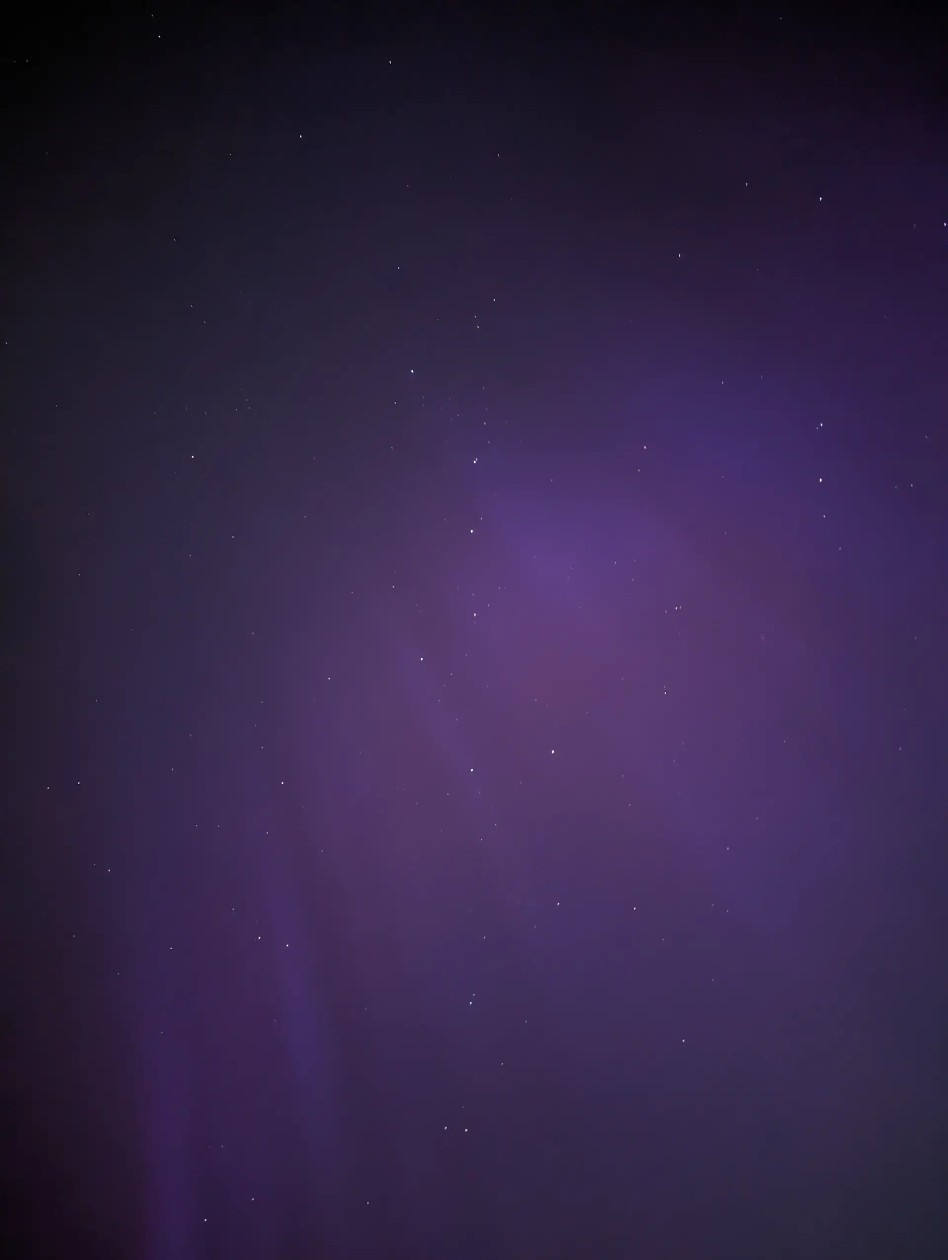 Night sky only with the Big Dipper in the middle with purple Northern Lights.