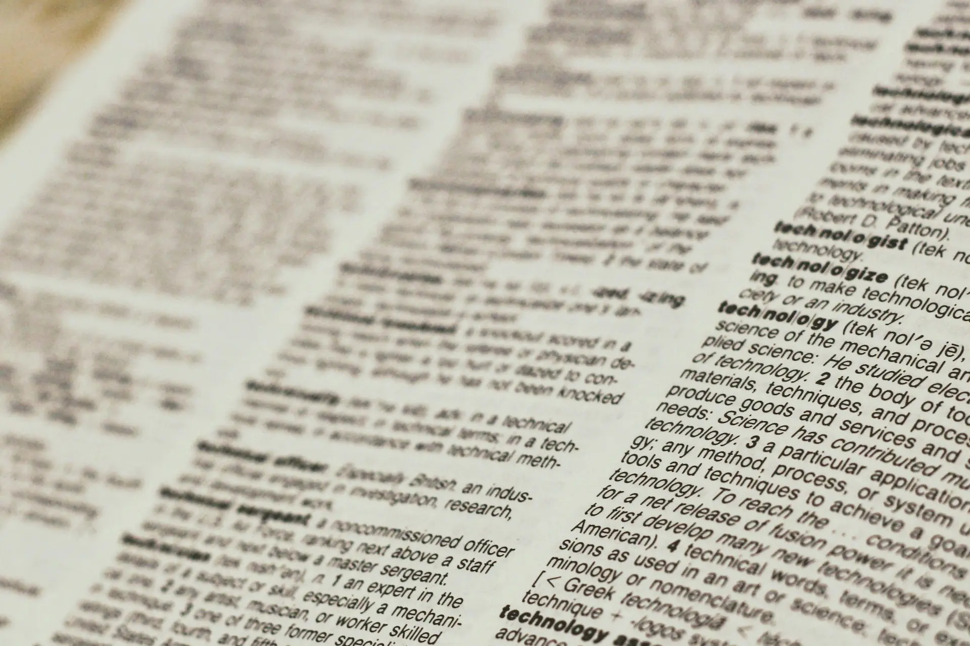 Picture of a page from a dictionary with the word “technology” being in focus.