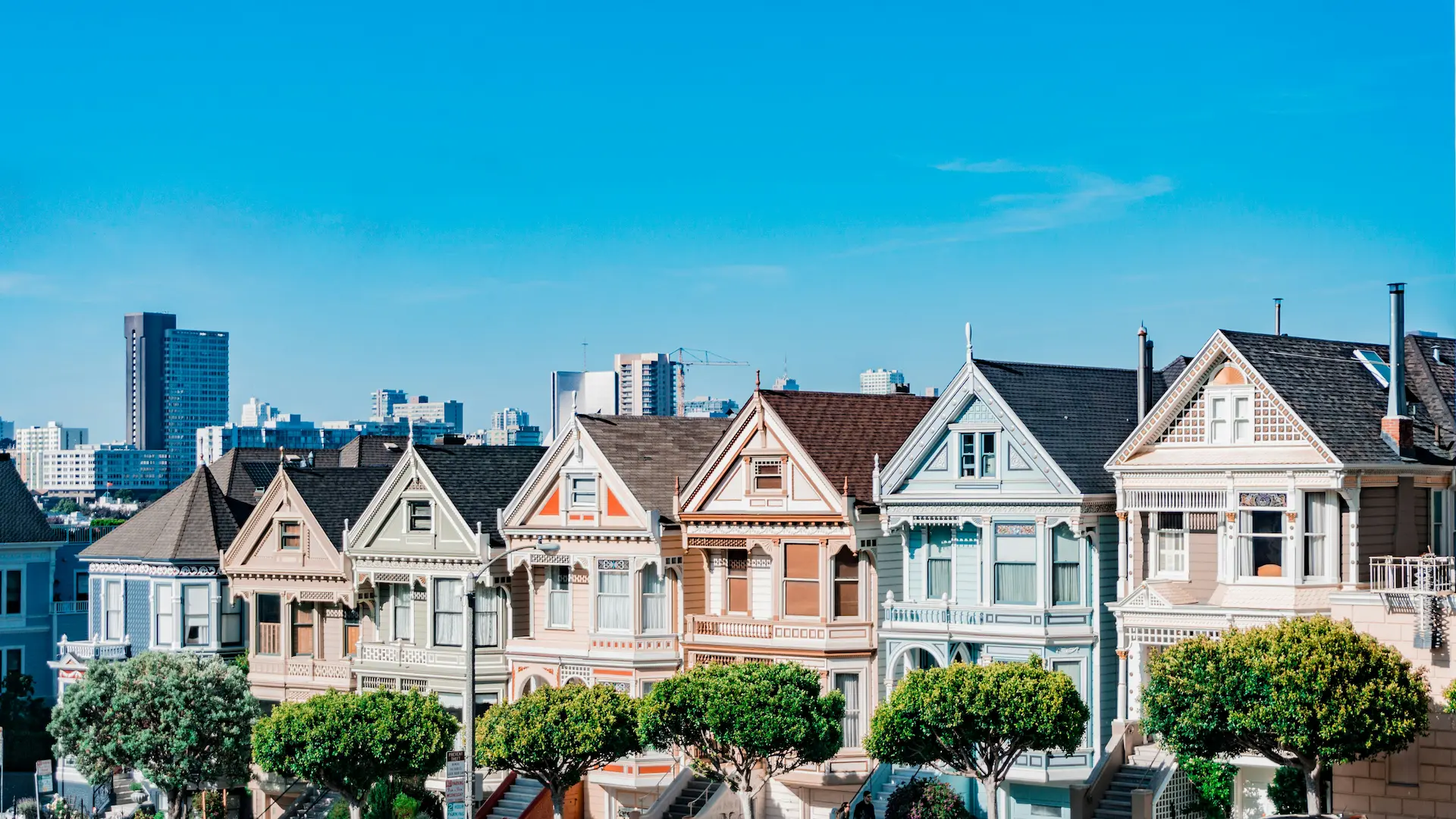 Photo of colourful terraced houses that look very similar to each other.