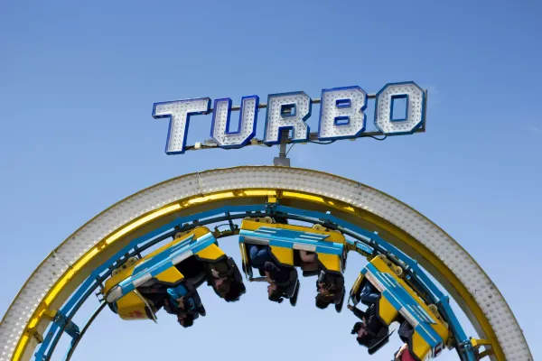 Upside down part of a rollercoaster loop with the coaster right there and the name Turbo on top.
