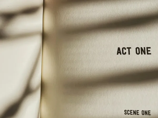 Photo of a book of a theatrical play. The only text visible is “act one, scene one.”
