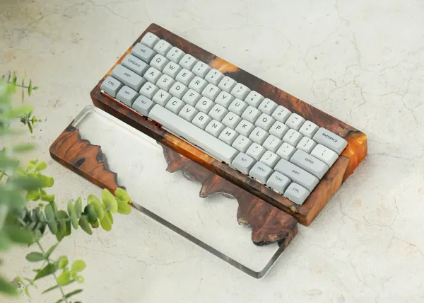 Mechanical keyboard in a wooden resin case with a wood/resin wrist rest.
