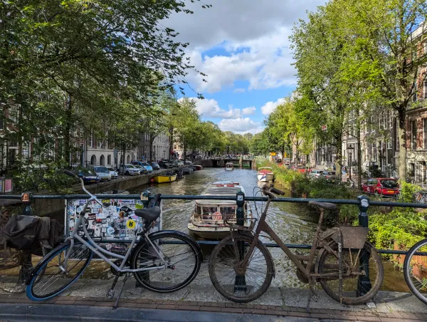 One of the canals in Amsterdam taken from the middle of a bridge. Bicycles in the foreground.