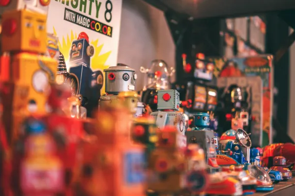 Toy robots displayed on a table at a game fair.