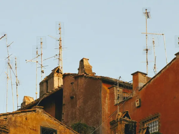 Old buildings with seemingly makeshift antennas on them.